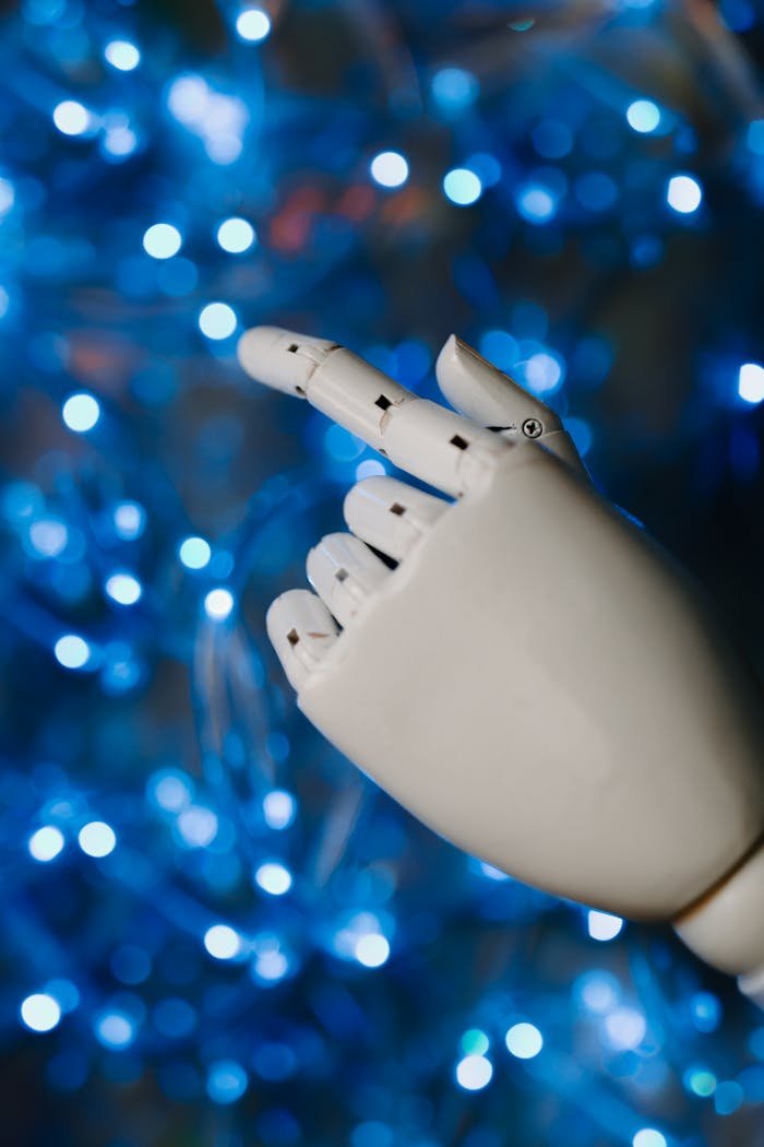 Close-up of a robotic hand with glowing blue bokeh background, symbolizing advanced technology.